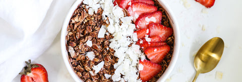 bowl topped with coconut and strawberries