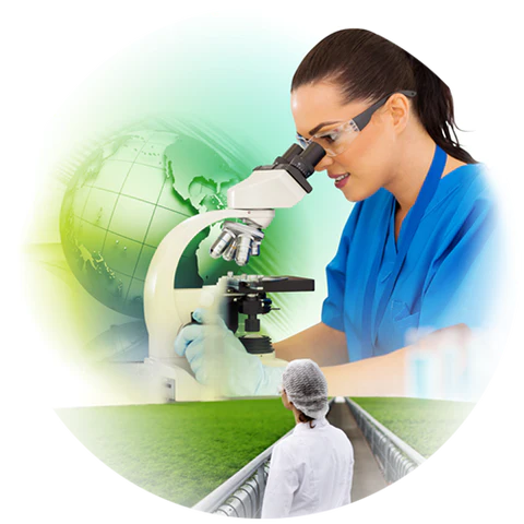 Woman looking through microscope with a globe in the background.